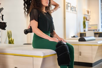 woman getting an assisted stretch using recovery tools at iFlex Stretch Studios