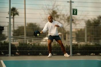 man playing pickleball with wide hip stance showing no signs of tight hip flexors