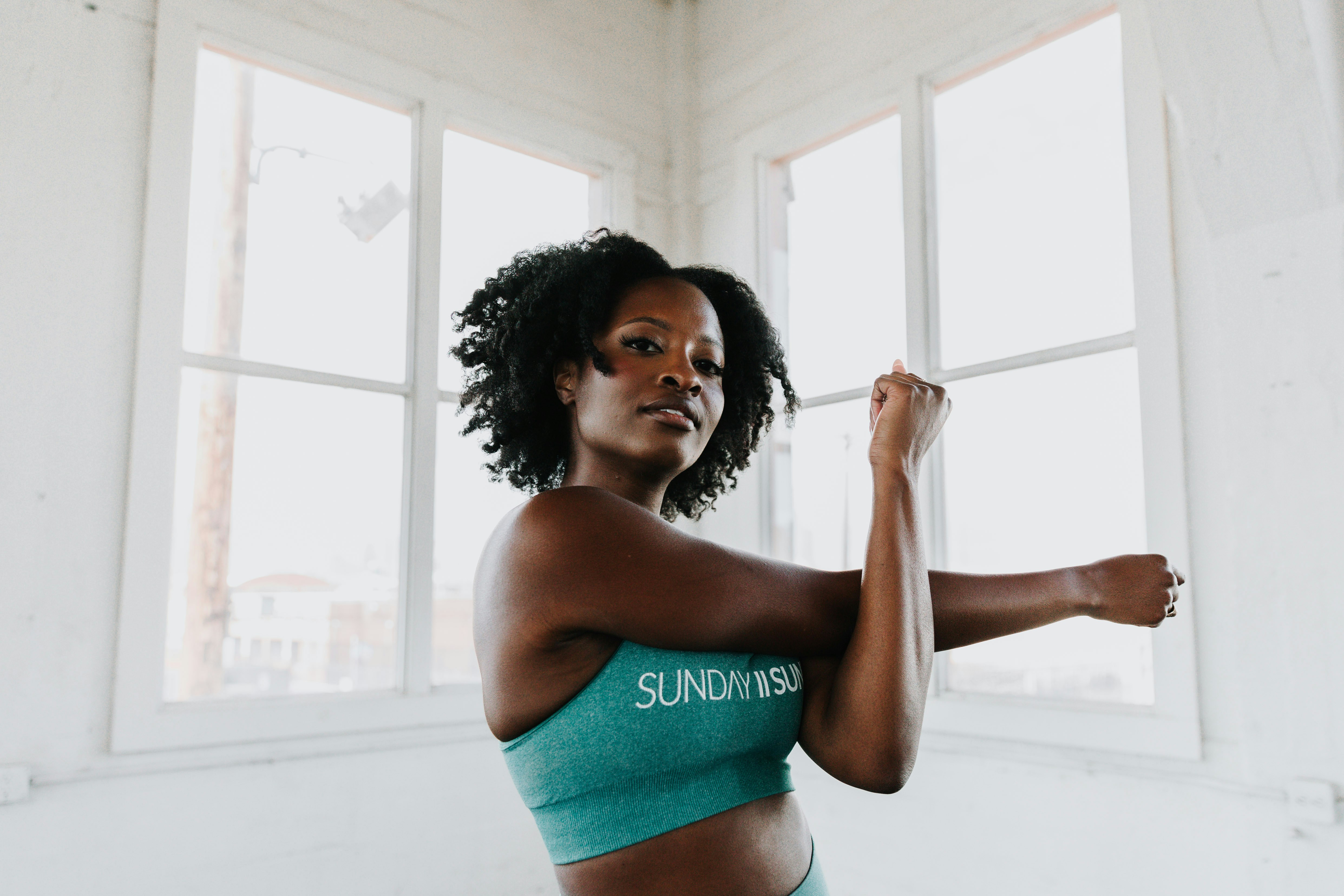 Young woman performing an upper body stretch as a mobility exercise